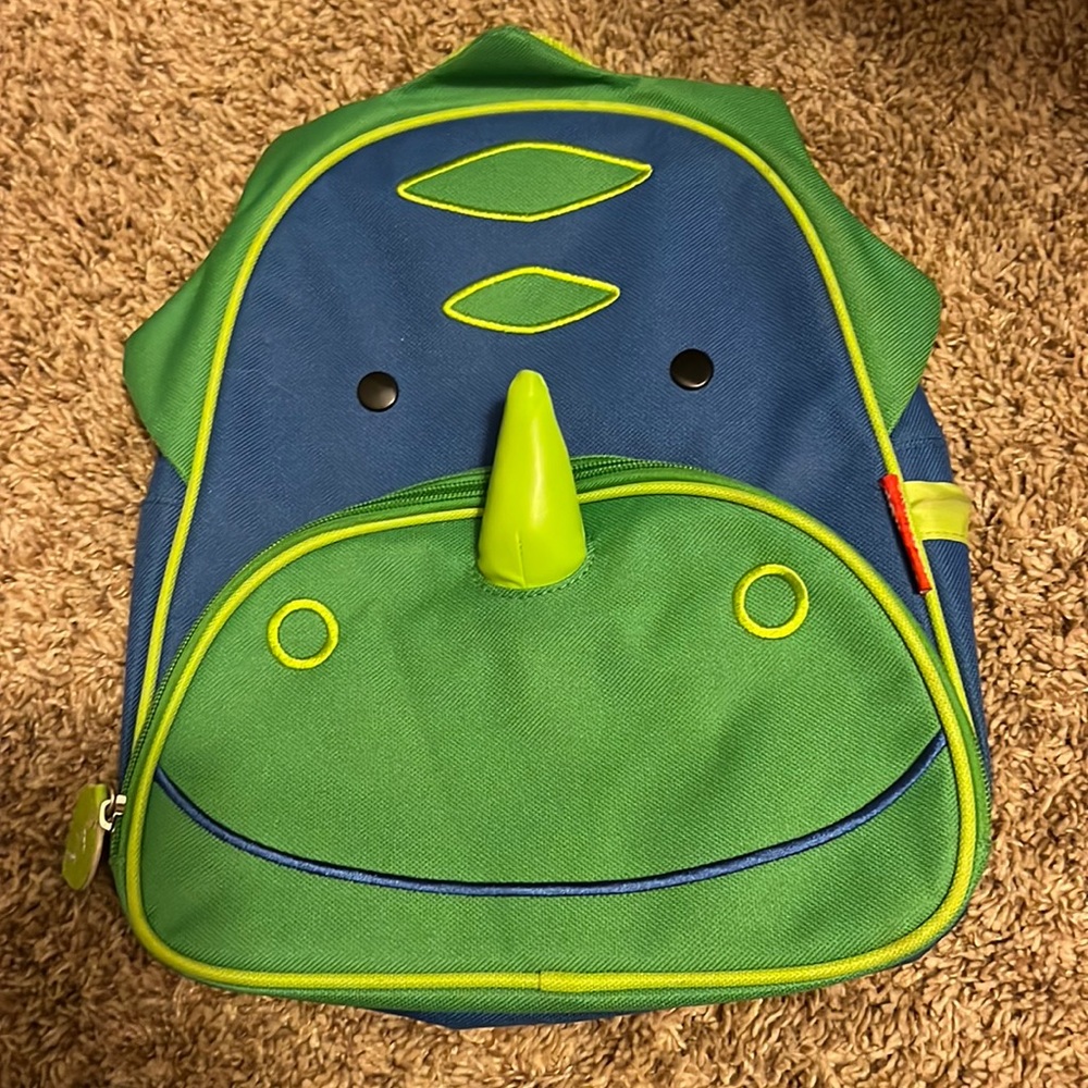 Skip Hop toddler dinosaur backpack with 2 zippered areas and one bottle holder